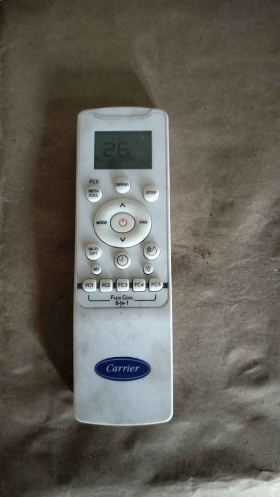 Carrier CAI18EE5R36F0 AC remote showing 26°C on LCD screen with swing, fan and mode controls