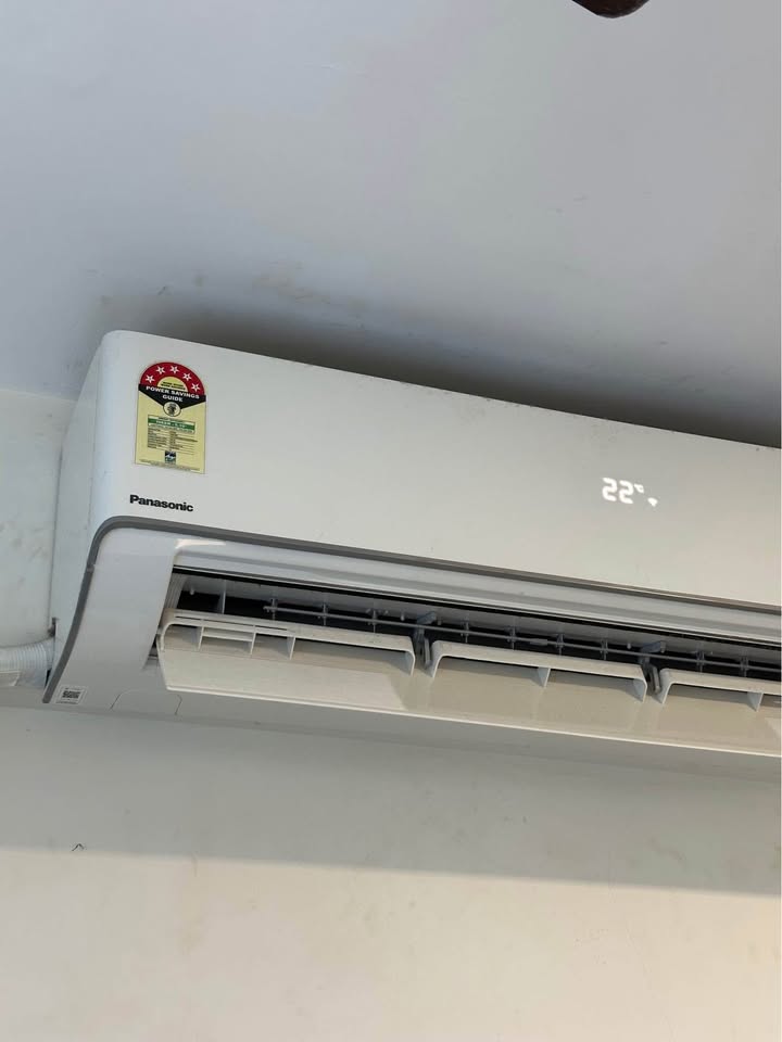 Panasonic 1.5 ton 5 star split AC indoor unit with LED display showing 22°C temperature setting