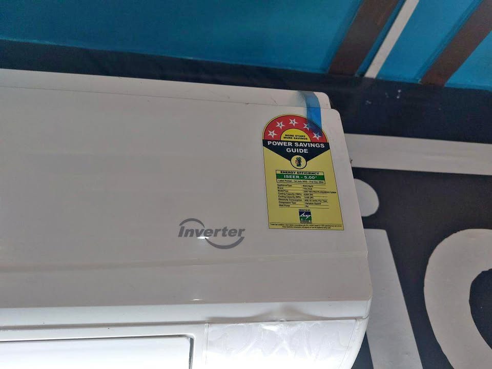 Close-up of BEE 5-star “Power Savings Guide” energy rating label on Voltas inverter split AC indoor unit (ISEER 5.00)