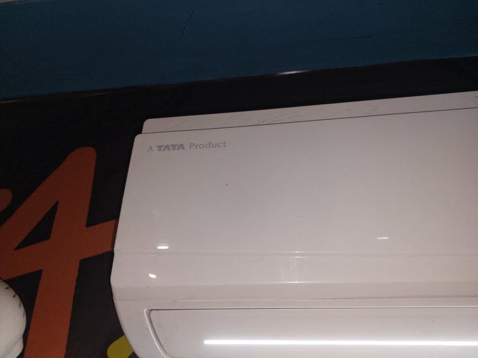 Close-up of Voltas Vectra CAR split AC indoor unit showing glossy white body finish and smooth front panel design